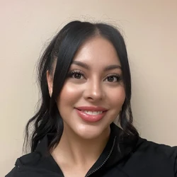 Mara, a dental assistant at Marine Hills Dentistry, is seen smiling warmly